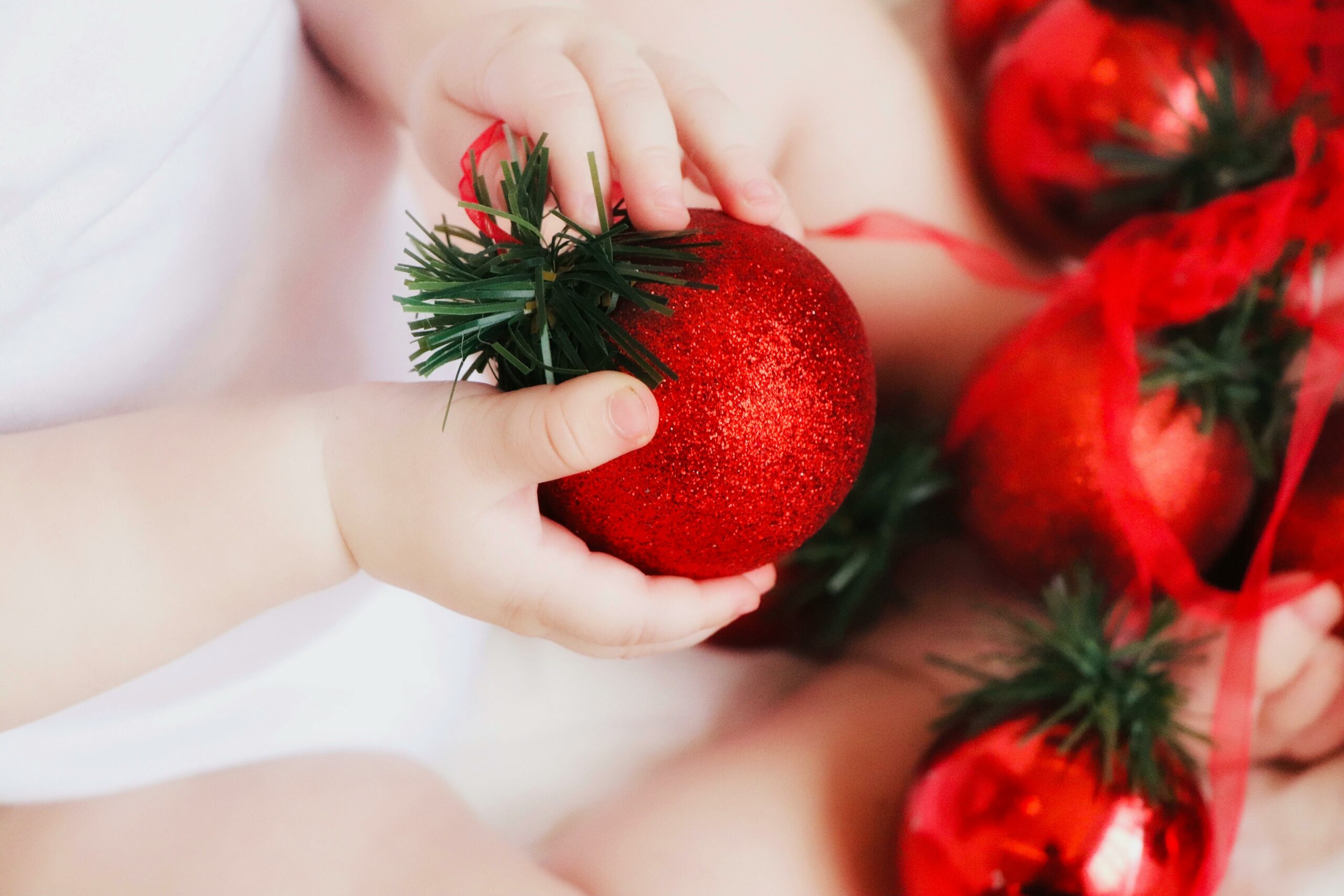 a child holding a Christmas bauble